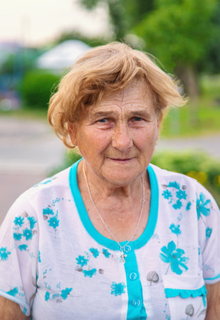 Old woman in the garden. Selective focus. Nature.の写真素材