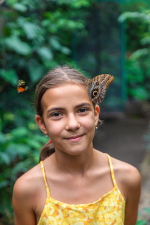 A child holds a beautiful butterfly. Selective focus. Nature.の写真素材