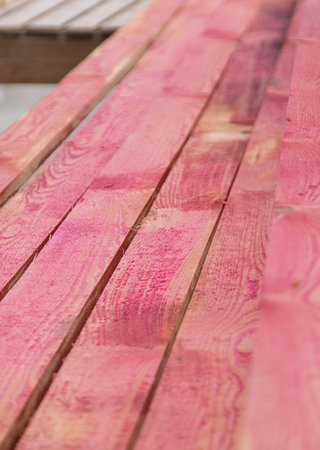 A man treats a board with a red antiseptic. selective focus. Nature.の写真素材