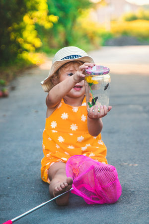 A child catches a butterfly in nature. selective focus. kid.の写真素材