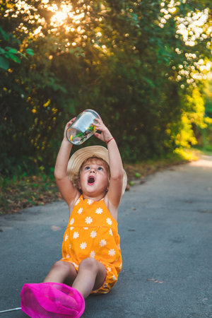 A child catches a butterfly in nature. selective focus. kid.の写真素材