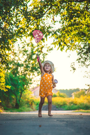 A child catches a butterfly in nature. selective focus. kid.の写真素材