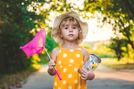A child catches a butterfly in nature. selective focus. kid.の写真素材
