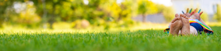 Child feet on the grass. Selective focus.の写真素材