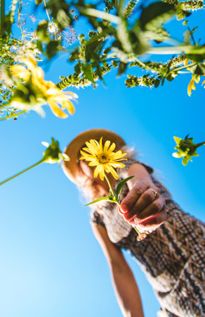Woman in the park with flowers summer. Selective focus.