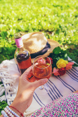 Wine flowers picnic in the garden woman. Selective focus.の写真素材