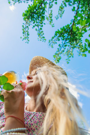 Wine flowers picnic in the garden woman. Selective focus.