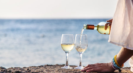 Glasses of wine on the seashore. Selective focus.の写真素材