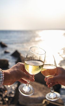 Glasses of wine on the seashore. Selective focus.の写真素材