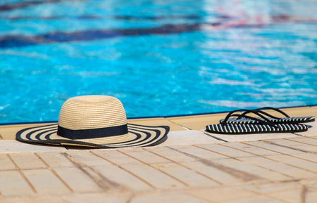 Hat and beach flip-flops. Selective focus.の写真素材