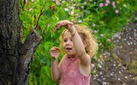 Child holding a snail on his hand. Selective focus.