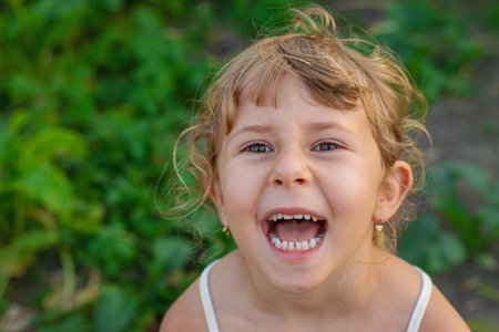 Child portrait in a garden. Selective focus.