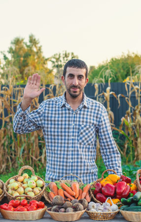 A farmer at a farmers market with vegetables. Selective focus.