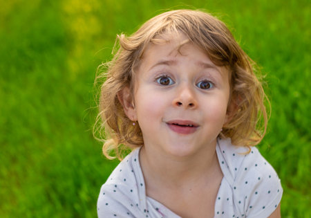 Portrait of a child on the grass. Selective focus.