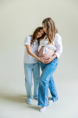 Pregnant woman with her eldest daughter. Selective focus.の写真素材
