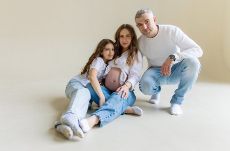 Pregnant woman with her family on a white background. Selective focus.の写真素材