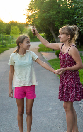 Spray mosquito repellent outdoors. Selective focus.の写真素材