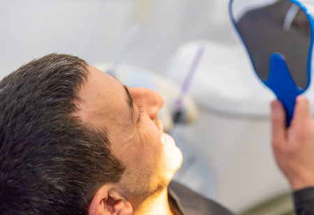 A man at a dentist appointment. Selective focus.の写真素材