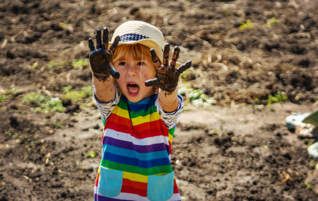 Child playing in mud. Selective focus.の写真素材