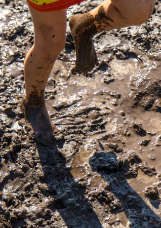 Child playing in mud. Selective focus.の写真素材