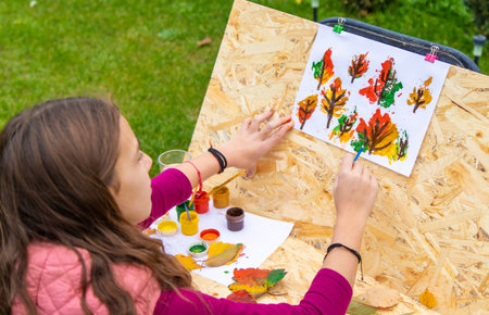 Child drawing autumn leaves. Selective focus.の写真素材
