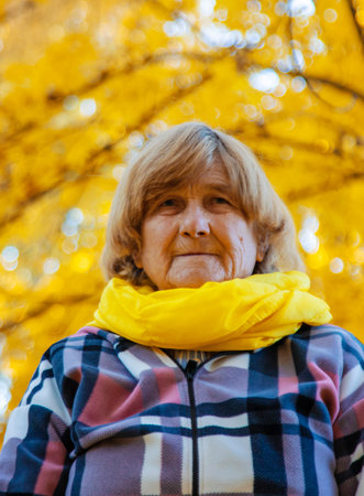 Senior woman in autumn park. Selective focus.の写真素材