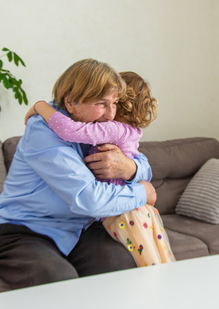 Old woman with her granddaughter. Selective focus.の写真素材