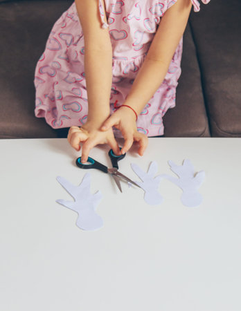Child holding paper cutout family. Selective focus.の写真素材