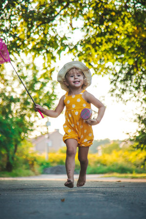 A child catches a butterfly in nature. selective focus.の写真素材
