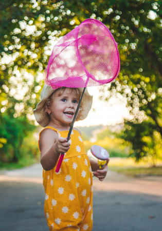 A child catches a butterfly in nature. selective focus.の写真素材