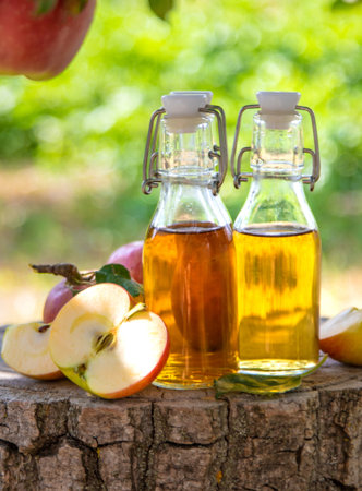Apple cider vinegar in the garden. Selective focus.の写真素材
