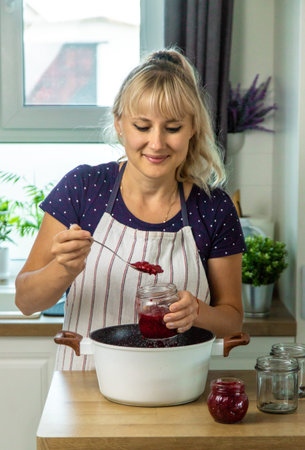 Raspberry jam in the hands of a woman. Selective focus.の写真素材