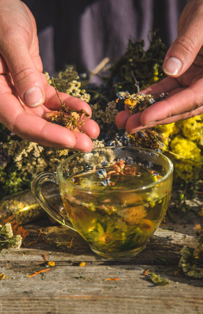 A woman brews herbal tea. Selective focus.の写真素材