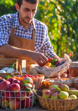 The farmer sells fruits and vegetables at the farmers market. Selective focus.の写真素材