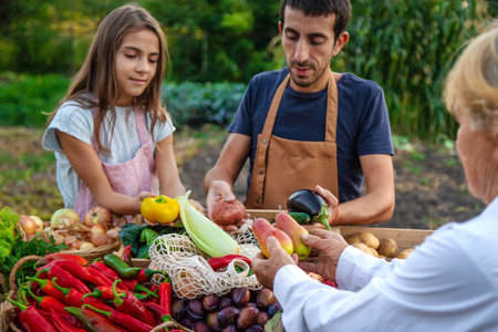 Father and daughter sell vegetables and fruits at the farmers market. Selective focus.の写真素材