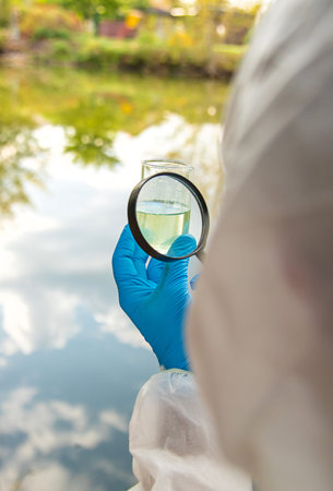 Take water samples for analysis. Selective focus.