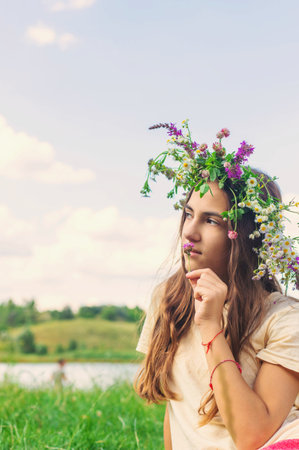 Child wearing a flower crown outdoors. Selective focus.