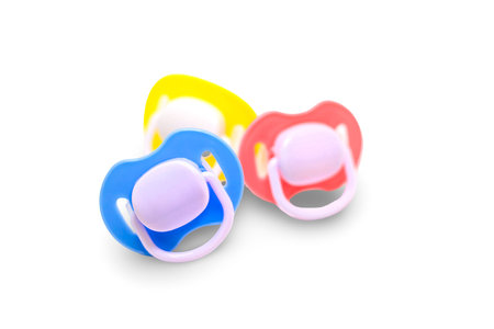 Dummy pacifiers for newborns in different colors. Selective focus.