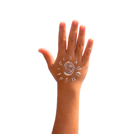 The child smears sunscreen on her hand. Selective focus.