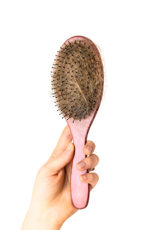 a lot of hair on the comb. Selective focus.