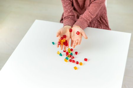 A child eats vitamin gummy candies. Selective focus.