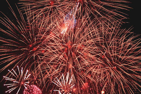 Red fireworks on dark background. Abstract background. Holiday concept. New year concept. Christmas...