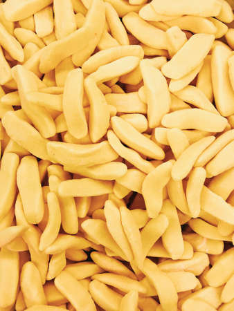 Yellow banana candies bright background. Flat lay, space