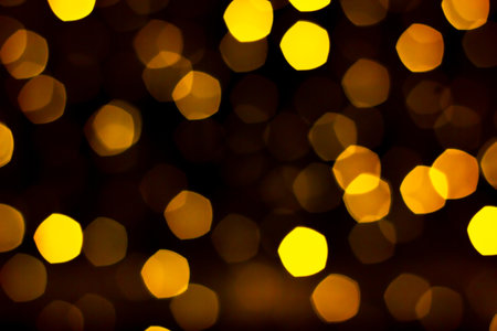 Illuminating festive bokeh lights and glitter in night holiday time. Presentation black backdrop...
