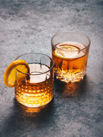 Two rock whiskey glasses with lemon cocktailの写真素材