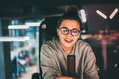 Young pretty woman broadcasting a podcast show remotely