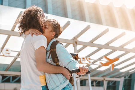 International couple meeting at airport departures areaの写真素材