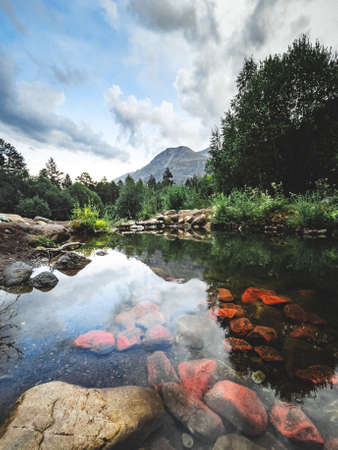 Vertical abstract landscape photo with mountains and river