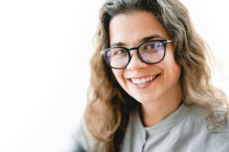 Young businesswoman in eyeglasses looking at the camera smiling