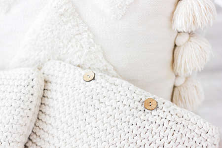 Soft white hygge pillows of knitted textile